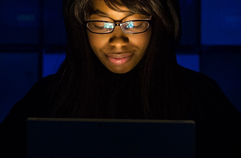 Woman’s Face Illuminated by Laptop